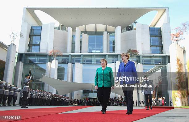 German Chancellor Angela Merkel and Chilean President Michelle Bachelet review a guard of honour upon Bachelet's arrival at the Chancellery on...