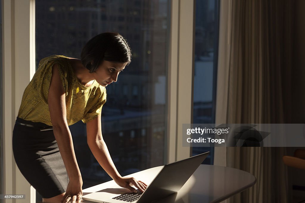 Woman looking at computer late at night