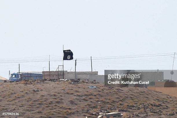 Islamic State black flag flies neasr the Syrian town of Kobani, October 27, 2014 as seen from the Turkish-Syrian border near the southeastern town of...