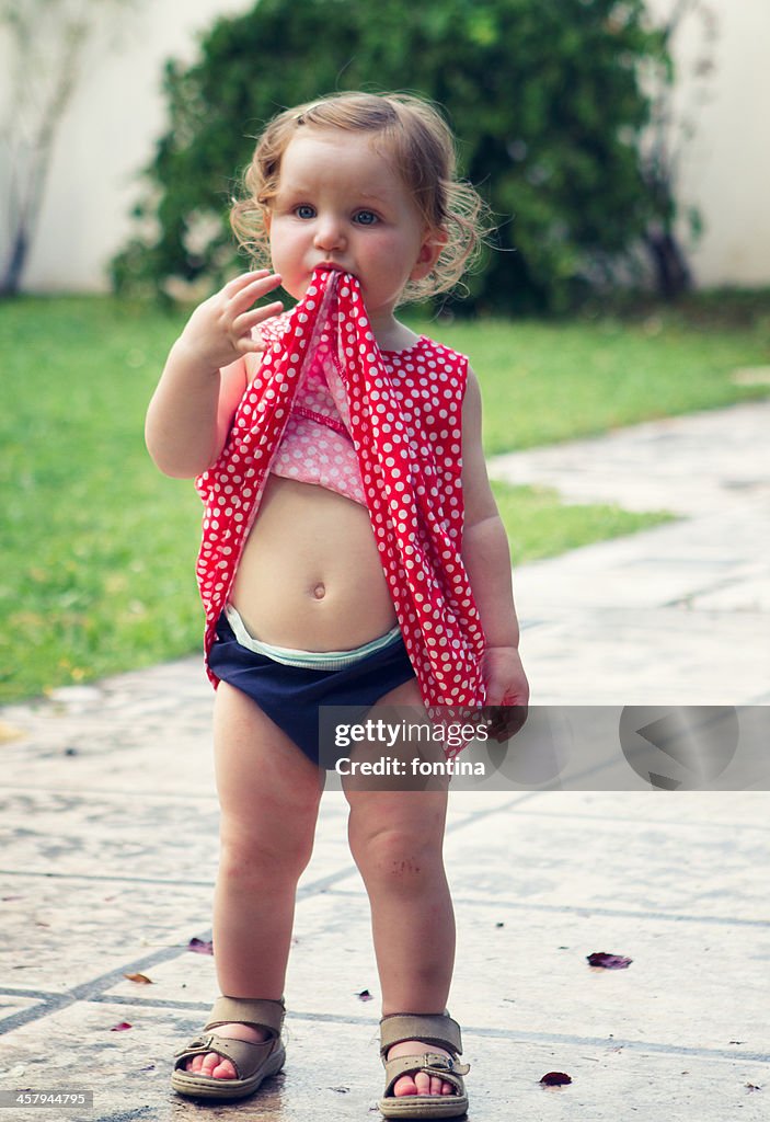 Toddler girl  playing in  the garden