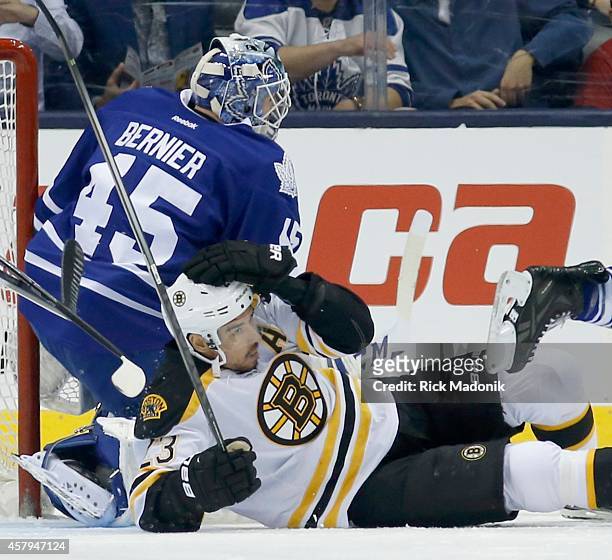 Bruins Chris Kelly gets levelled in front of Leaf goalie Jonathan Bernier. Toronto Maple Leafs vs. Boston Bruins during 1st period action of NHL...