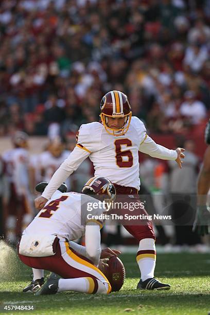 Shaun Suisham of the Washington Redskins kicks a field goal on hold by Derrick Frost during a game against the Philadelphia Eagles on December 10,...