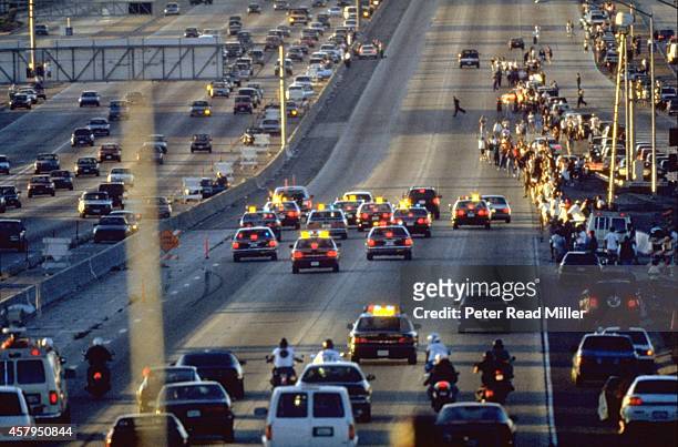 View of white Ford Bronco being driven by Al Cowling on Interstate 405. Former NFL running back O.J. Simpson hiding in the car after failing to turn...