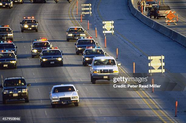 View of white Ford Bronco being driven by Al Cowling on Interstate 405. Former NFL running back O.J. Simpson hiding in the car after failing to turn...