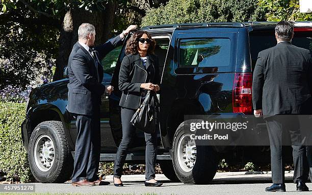 First lady Michelle Obama returns to the White House after with U.S. President Barack Obama after attending a parent/teacher conferences for their...