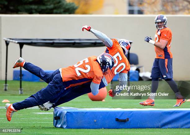 Shaquil Barrett and Corey Nelson run through several drills with the rest of the linebackers as the Denver Broncos football team practices at Dove...