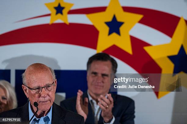 Sen. Pat Roberts is applauded by Former Massachusetts Former Massachusetts Gov. Mitt Romney as he speaks during a rally at the Prairie Fire shopping...