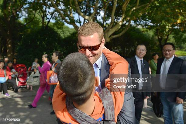 Dutch artist Florentijn Hofman, "Father of Rubber Duck", plays at Century Park on October 23, 2014 in Shanghai, China. "Rubber Duck", designed by...