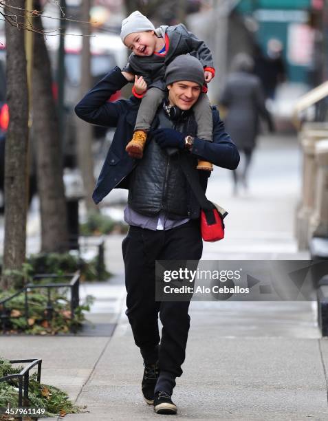 Orlando Bloom and Flynn Christopher Bloom are seen in Midtown on December 19, 2013 in New York City.
