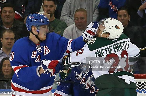 Marc Staal of the New York Rangers gets the glove up on Nino Niederreiter of the Minnesota Wild during the second period at Madison Square Garden on...