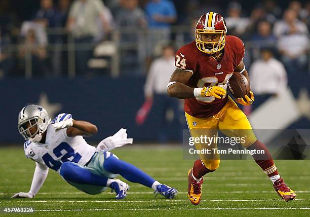 Niles Paul of the Washington Redskins runs after the catch as Barry Church of the Dallas Cowboys is unable to make the tackle during the first half...