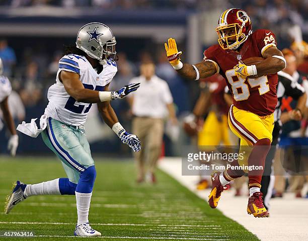 Niles Paul of the Washington Redskins is forced out of bounds by J.J. Wilcox of the Dallas Cowboys during the first half at AT&T Stadium on October...