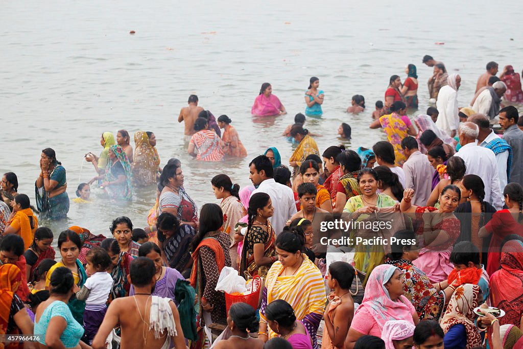 Hindu devotees pray before taking holy dip in the River...