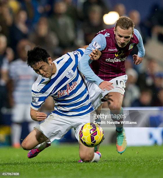 Andreas Weimann of Aston Villa is challenged by Suk Young Yun of Queens Park Rangers during the Barclays Premier League match between Queens Park...