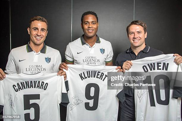 Michael Owen , Patrick Kluivert and Fabio Cannavaro pose with t-shirts at a Global Legends Series media event on October 27, 2014 in Kuala Lumpur,...