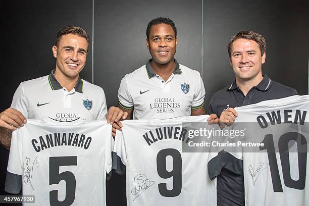 Michael Owen , Patrick Kluivert and Fabio Cannavaro pose with t-shirts at a Global Legends Series media event on October 27, 2014 in Kuala Lumpur,...
