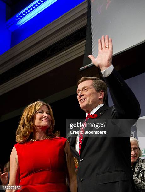 John Tory, mayor-elect of Toronto, right, waves to the crowd as his wife Barbara Hackett looks on after Tory delivered his victory speech at an...
