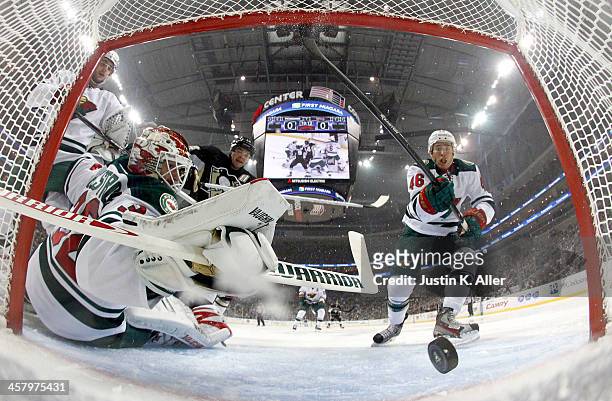 Niklas Backstrom of the Minnesota Wild can't make the save on Pascal Dupuis of the Pittsburgh Penguins during the game at Consol Energy Center on...