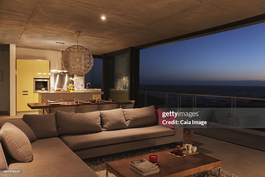 Sofa and dining table in modern living room overlooking ocean