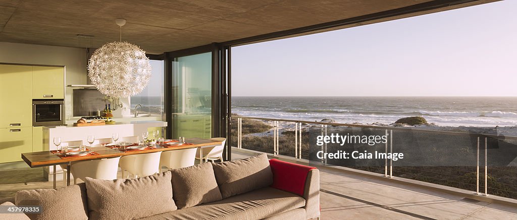 Modern living room and dining room overlooking ocean