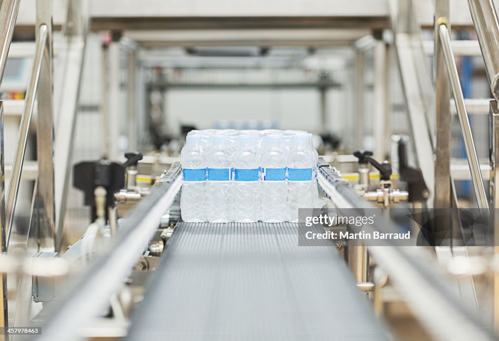 Water bottles on conveyor belt in factory