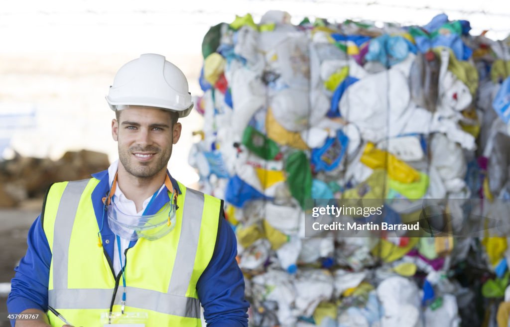 Worker smiling in recycling center