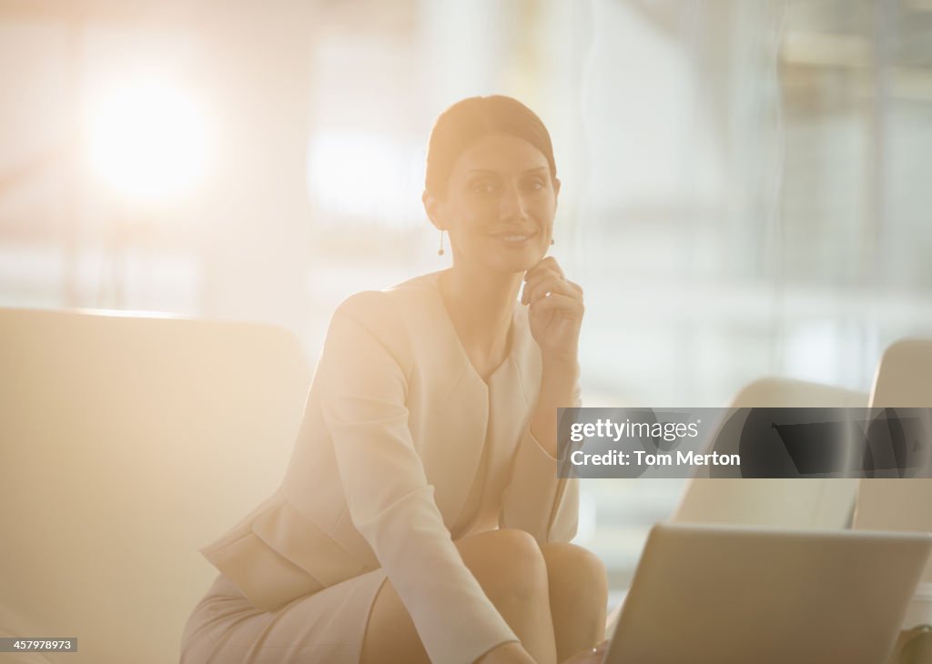 Businesswoman using laptop in office