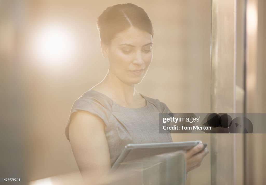 Businesswoman using digital tablet in office