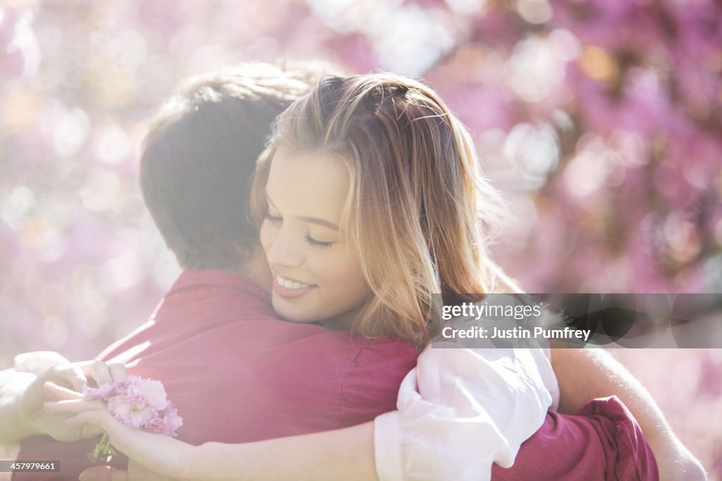 Couple hugging outdoors