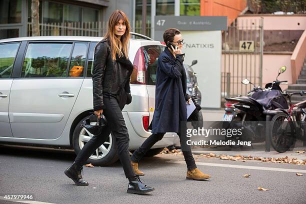Caroline de Maigret and Agathe Mougin enter the Anthony Vaccarello show on September 23, 2014 at Les Docks in Paris, France. Caroline wears an...