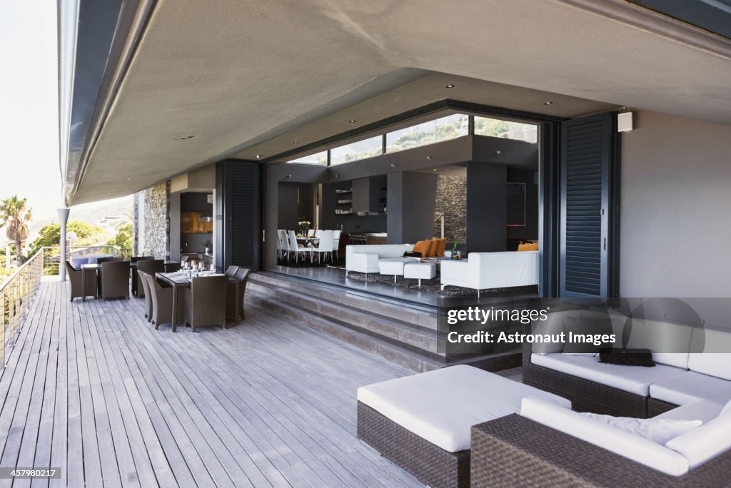 Sofa, tables and chairs on modern balcony