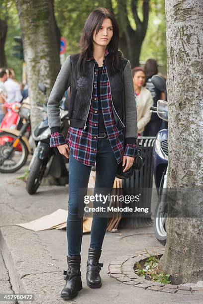 Estonian model Katlin Aas exits Jil Sander while carrying an Alexander Wang bag and wearing Acne Studios boots on Day 4 of Milan Fashion Week...