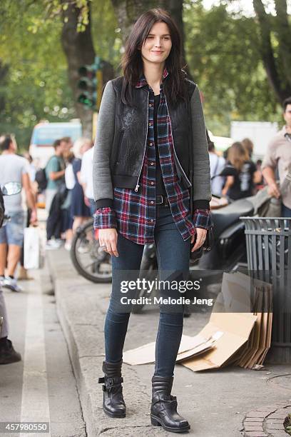 Estonian model Katlin Aas exits Jil Sander while carrying an Alexander Wang bag and wearing Acne Studios boots on Day 4 of Milan Fashion Week...