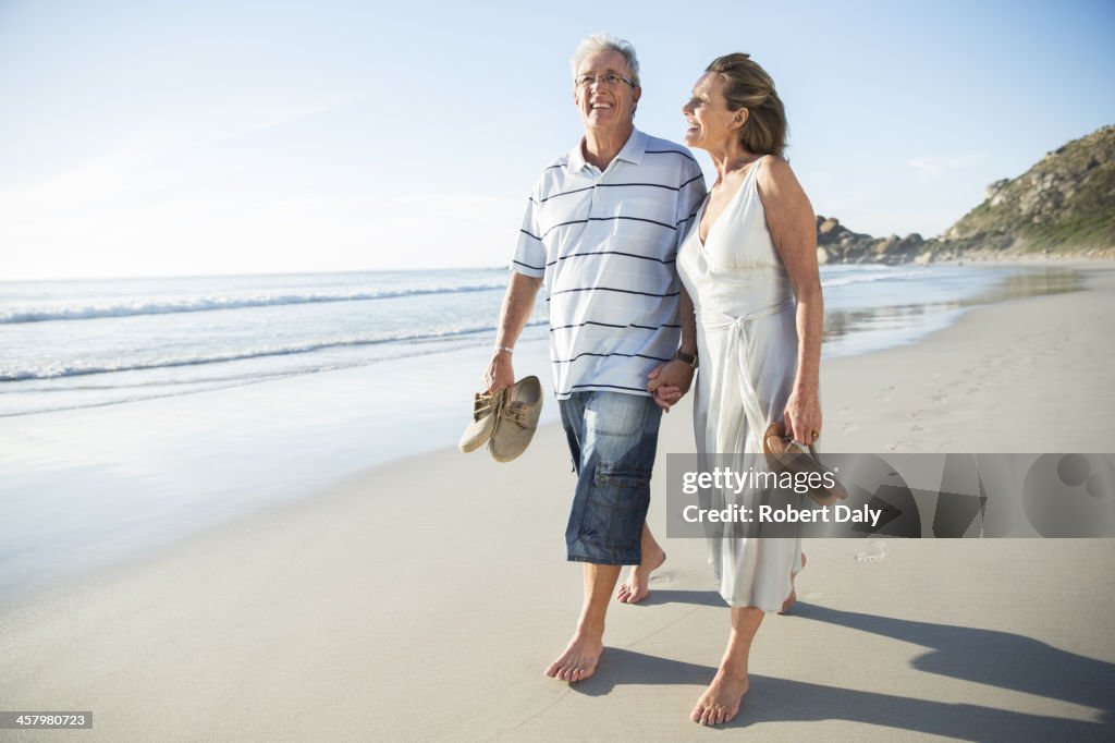 Senior couple walking on beach