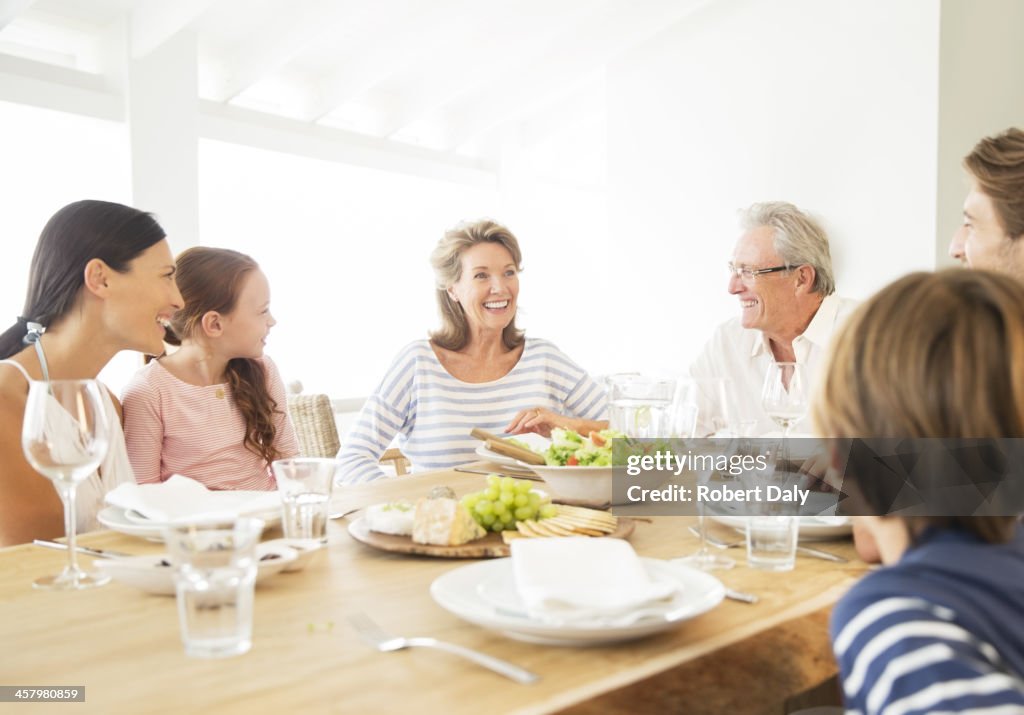Multi-generation family eating together at table