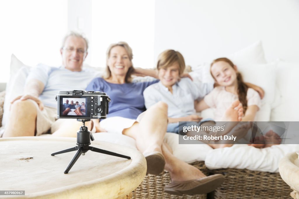 Family taking picture of themselves on sofa