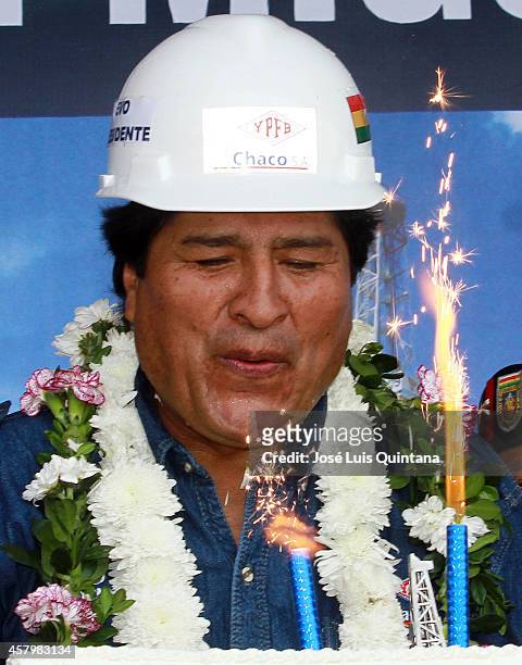 President of Bolivia Evo Morales blows out the candles of his cake during the celebration of his 55th birthday during a tour of inspection at San...
