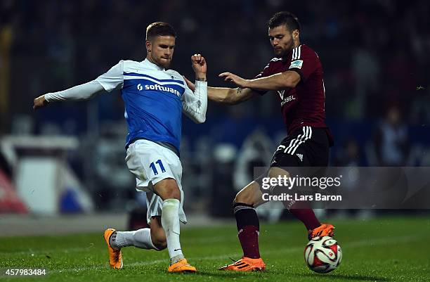 Tobias Kempe of Darmstadt is challenged by Ondrej Celustka of Nuernberg during the 2. Bundesliga match between SV Darmstadt 98 and 1. FC Nuernbeurg...