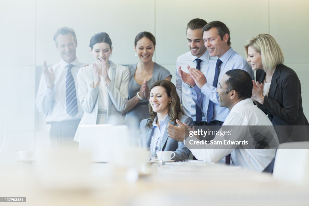 Business people cheering in meeting