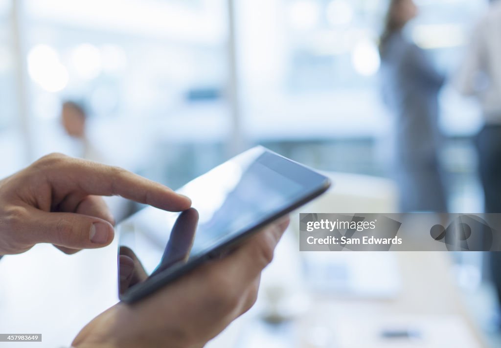 Homme d'affaires à l'aide de tablette numérique dans bureau