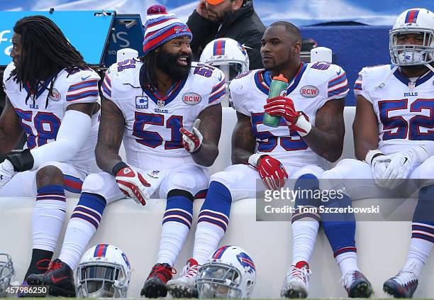 Brandon Spikes of the Buffalo Bills talks to Nigel Bradham on the bench during NFL game action against the Minnesota Vikings at Ralph Wilson Stadium...