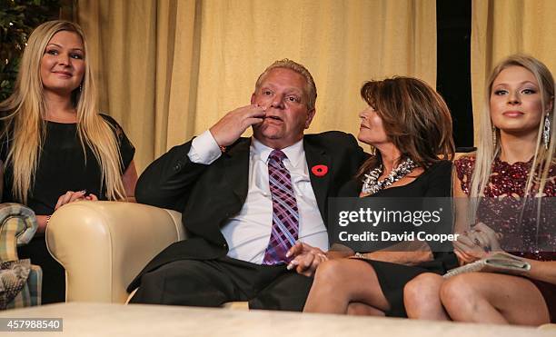 Doug Ford puts his hand to his face as he sits with his wife Karla in the basement of the Ford family home in Toronto. October 27, 2014.