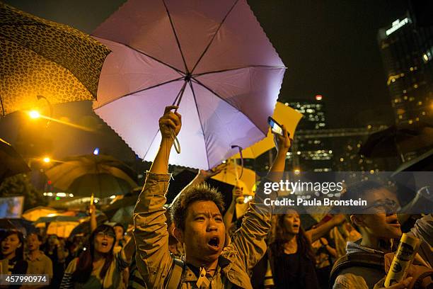 Umbrellas are opened as tens of thousands come to the main protest site one month after the Hong Kong police used tear gas to disperse protesters...