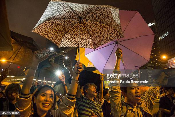 Umbrellas are opened as tens of thousands come to the main protest site one month after the Hong Kong police used tear gas to disperse protesters...