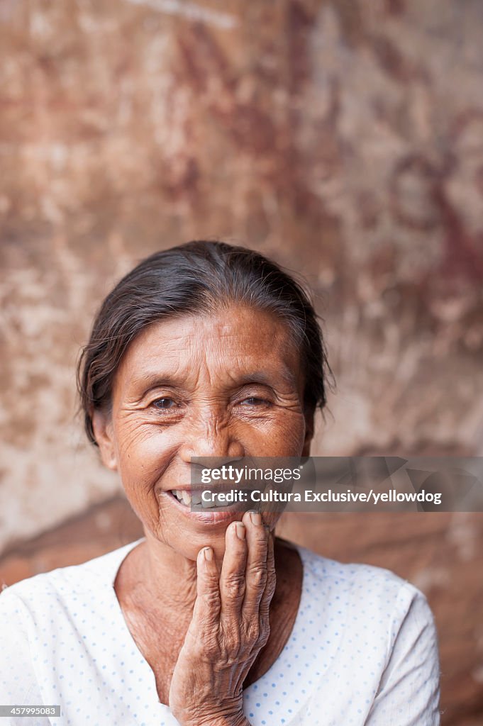 Mature woman with hand on chin, Bagan, Burma