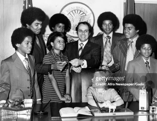 Marlon Jackson, Joseph Jackson, Azira Hill, Jermaine Jackson, Mayor Sam Massell, Jackie, Tito and Michael Jackson stand while the Mayor's daughter...
