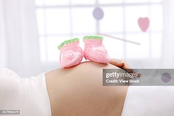 pregnant woman - chinese baby shoe stock pictures, royalty-free photos & images