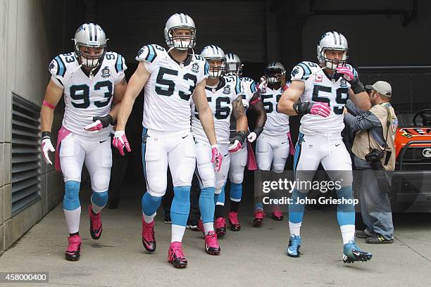 Chase Blackburn, Ben Jacobs and Luke Kuechly of the Carolina Panthers take the field for their game against the Cincinnati Bengals at Paul Brown...