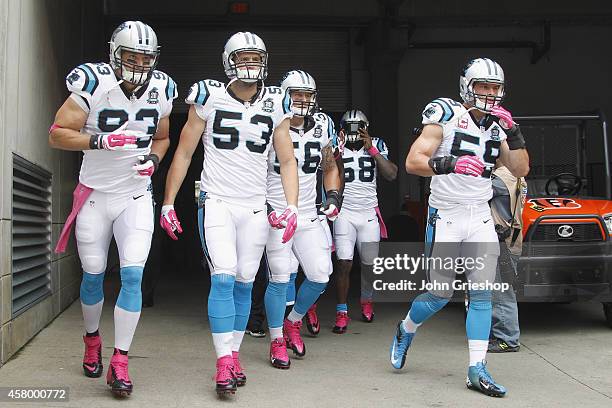 Chase Blackburn, Ben Jacobs and Luke Kuechly of the Carolina Panthers take the field for their game against the Cincinnati Bengals at Paul Brown...