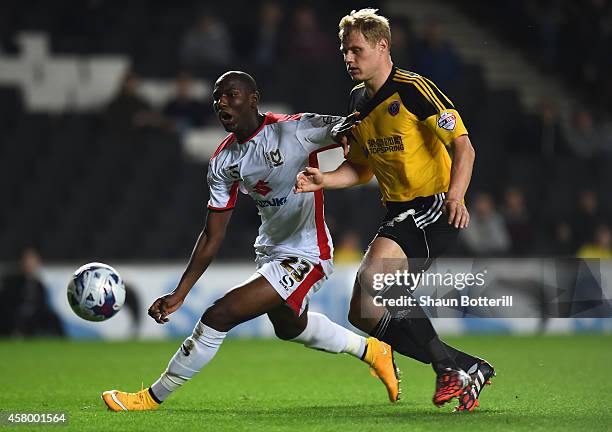 Benik Afobe of MK Dons is tackled by Jay McEveley of Sheffield United during the Capital One Cup Fourth Round match between MK Dons and Sheffield...